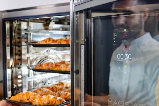Chef taking brioches out of magistar combi oven